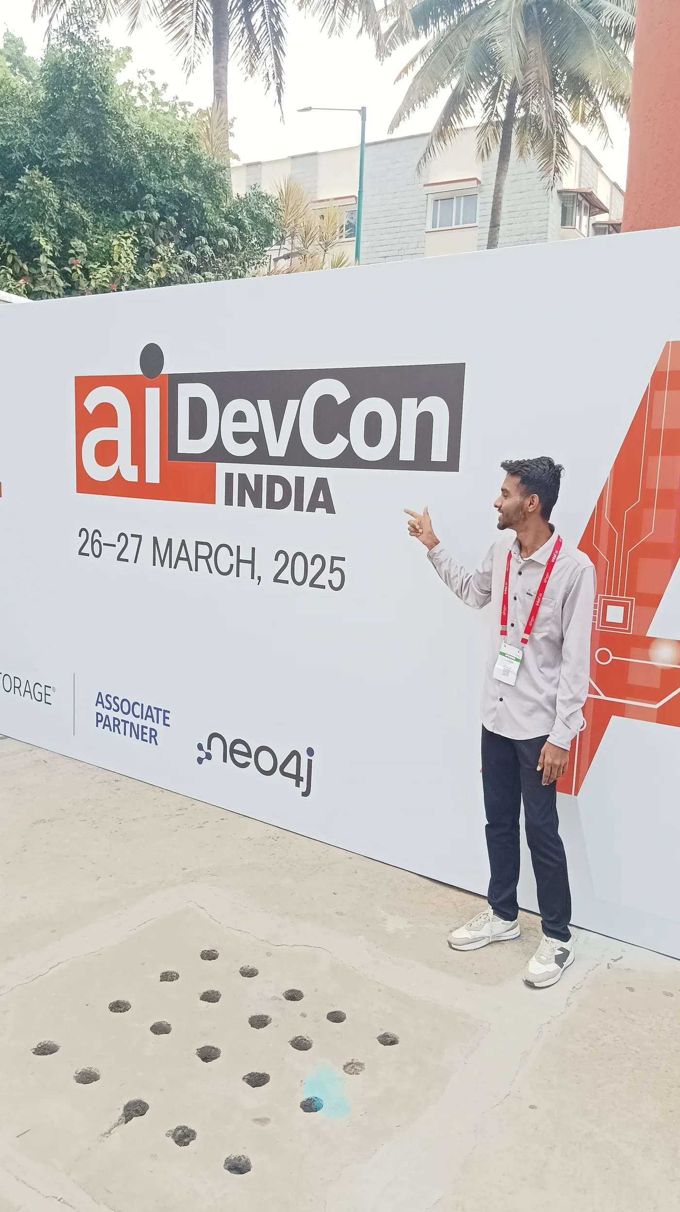C Sarath Babu at AIDevCon India 2025, standing beside the conference banner at NIMHANS Convention Center