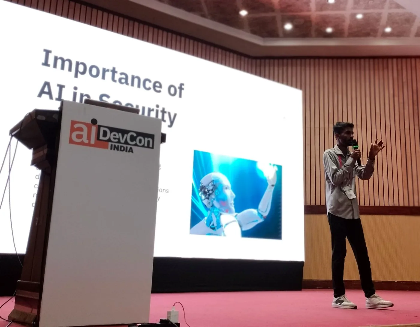 C Sarath Babu on stage at AIDevCon India 2025, presenting beside the podium