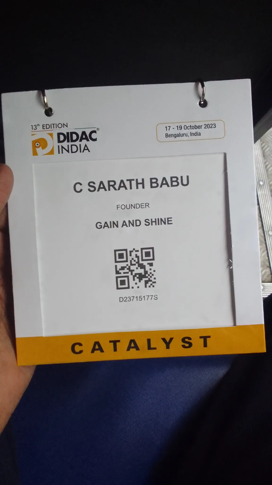 C Sarath Babu's writing on DIDAC INDIA 2023. His visitor badge reading C Sarath Babu, Founder, Gain and Shine