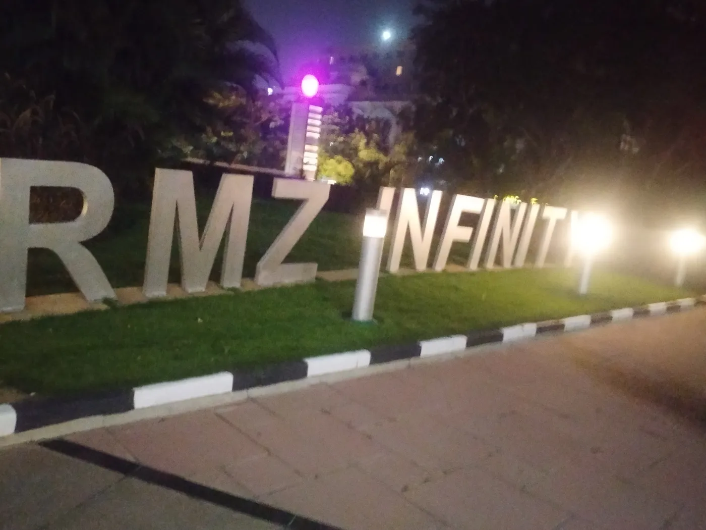 C Sarath Babu's writing on Google I/O Extended Bengaluru, 2023. The RMZ Infinity sign lit at night