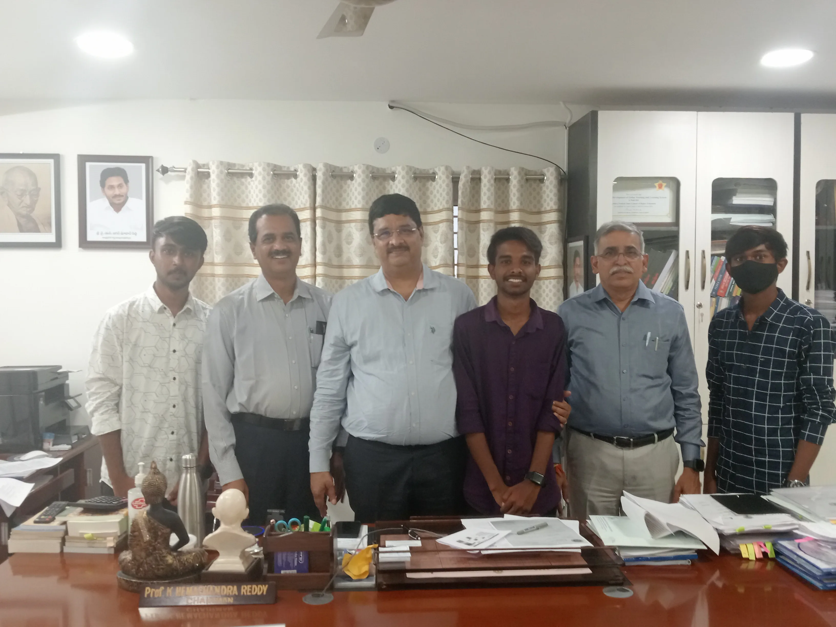 C Sarath Babu's writing on the APSCHE award, 2023. Sarath and Pavan with APSCHE chairman Prof. K. Hemachandra Reddy in his office