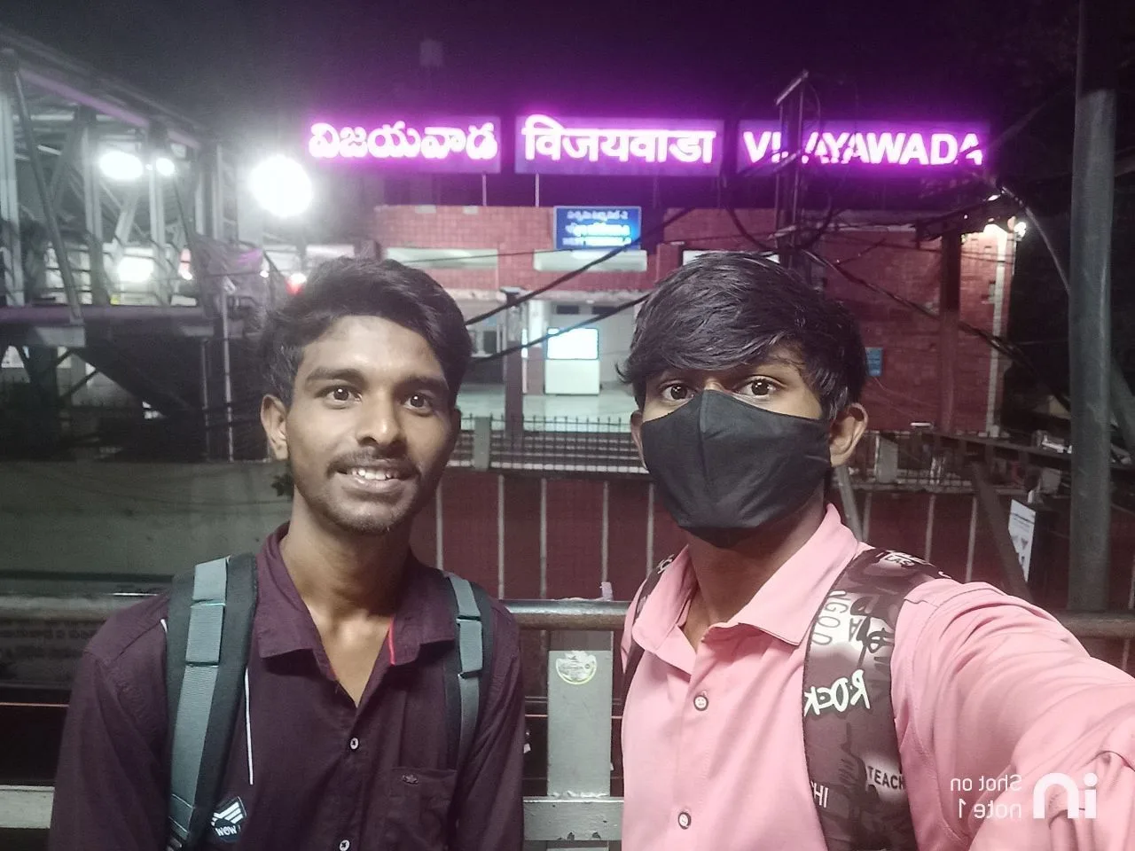 C Sarath Babu's writing on the APSCHE award, 2023. Sarath and Pavan under the Vijayawada station sign
